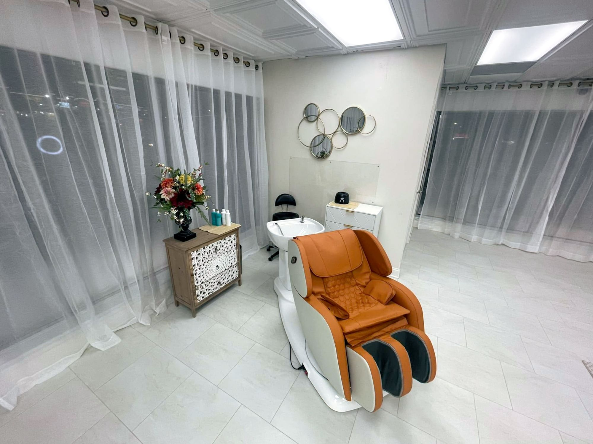 Interior of Urban Vintage Hair Studio in Cedar Rapids showing a private shampoo area with a massage chair.